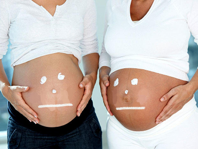 Two pregnant woman are next to each other with their shirts lifted to show their stomachs. On their stomachs is a drawn straight face expression.