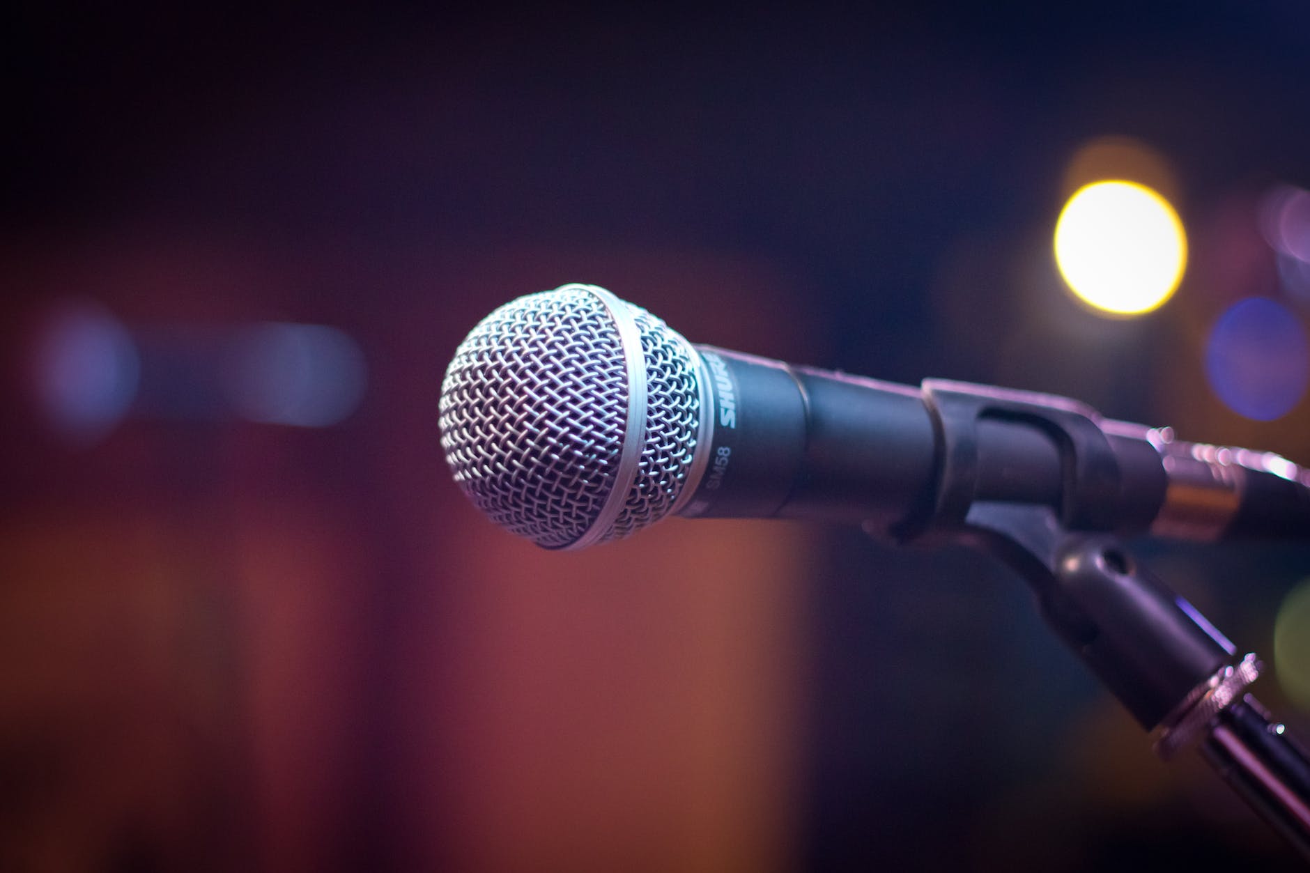 Image of a microphone in front of a blurred background.